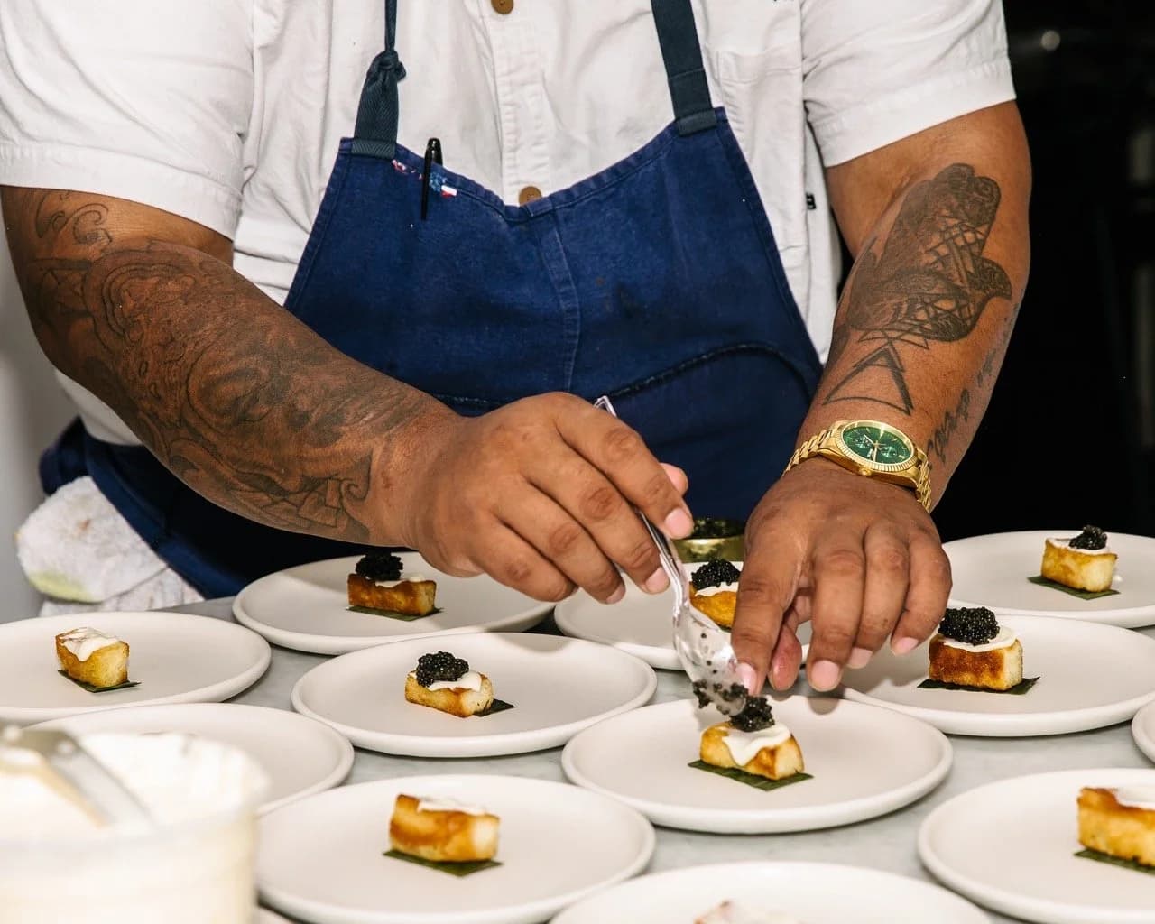 A chef plating small bites for a client event