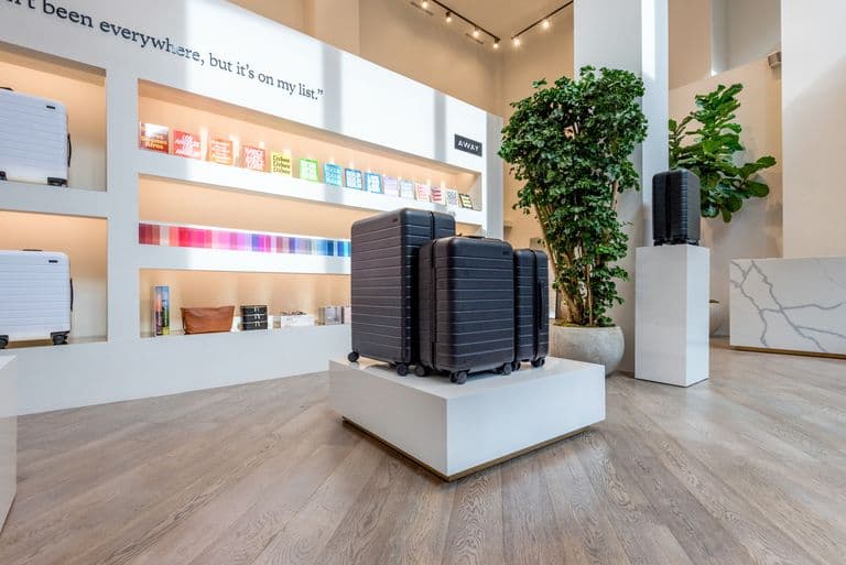 Bright Away store featuring luggage, backpacks, and travel accessories organized on sleek shelving.