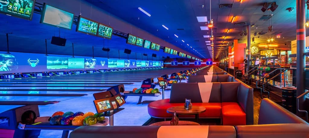 Colorful bowling lanes with neon lights and a lively atmosphere at Bowlero.