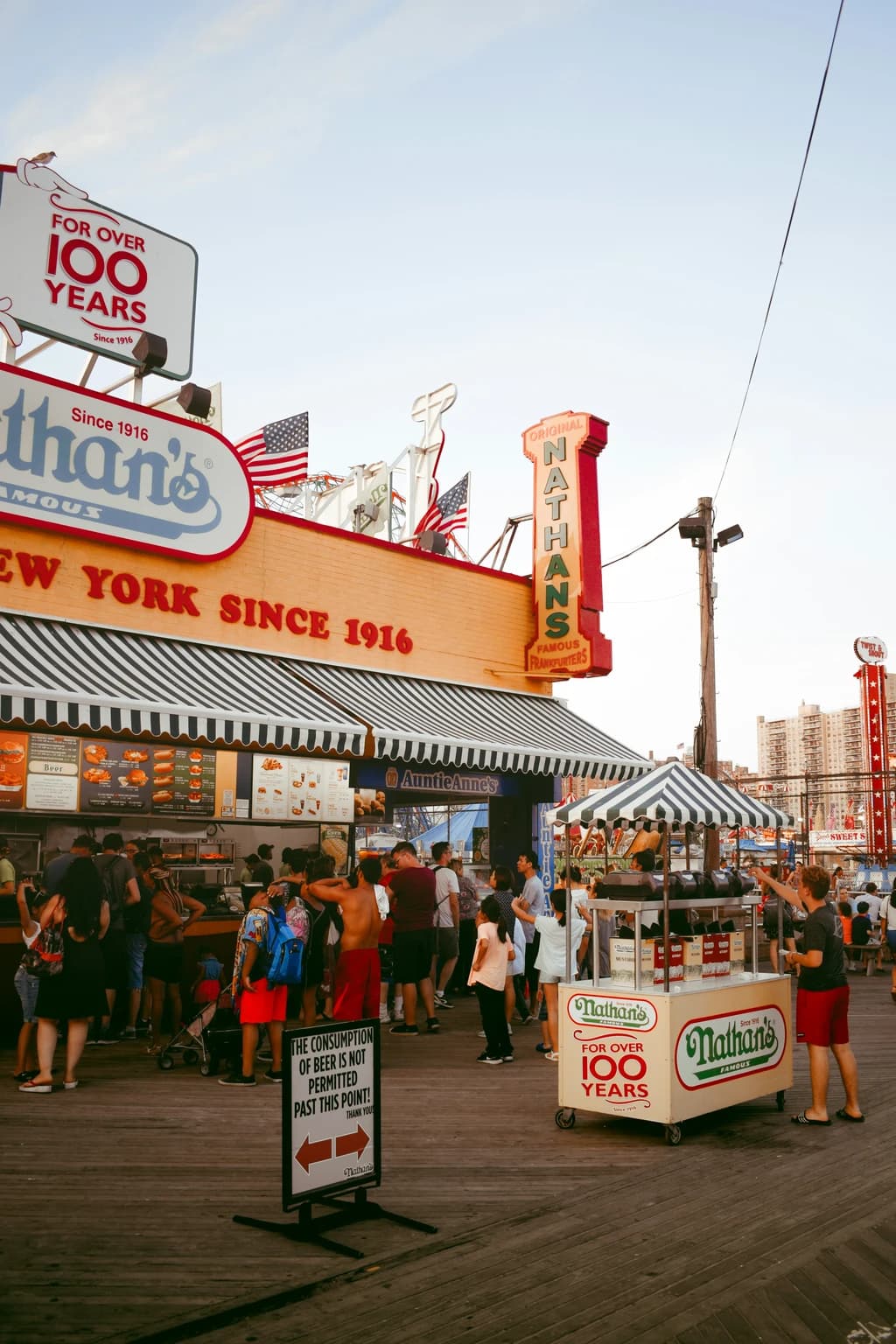 the coney island boardwalk with nathans hot dog stand in the background
