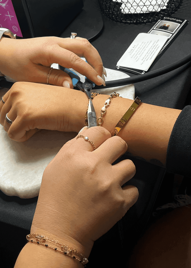 Technician carefully welding custom permanent bracelet during on-site event setup