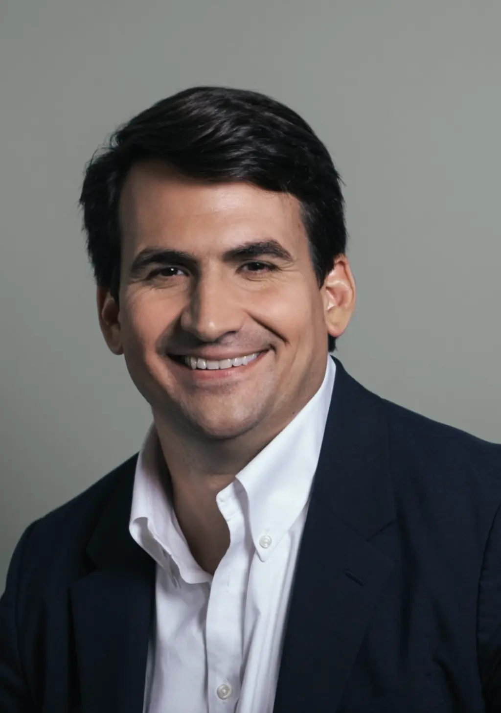 a man dressed up and smiling at the camera