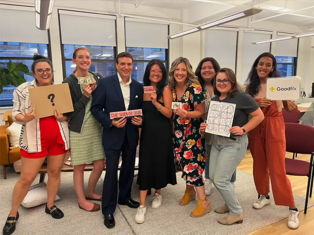 a group of people holding up cards from their magic show
