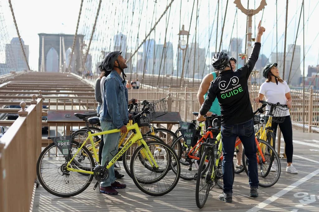 a women riding a bike in with the new york skyline in the background