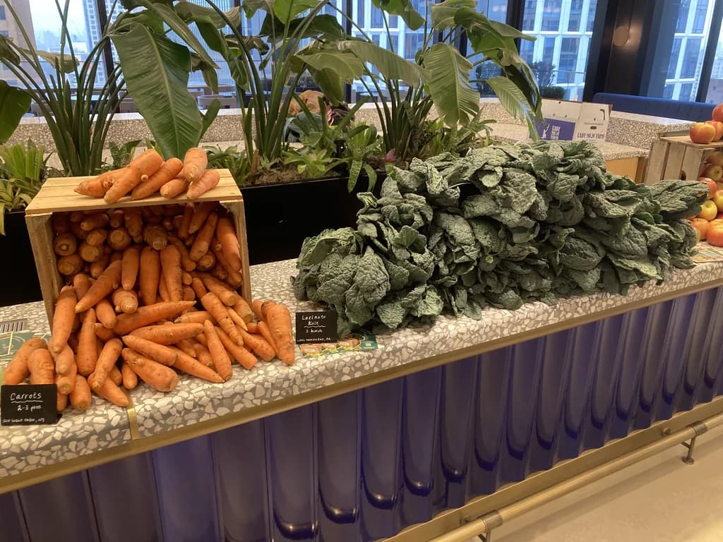 close up of a persons bag with various produce items in it, and a table with more items on it