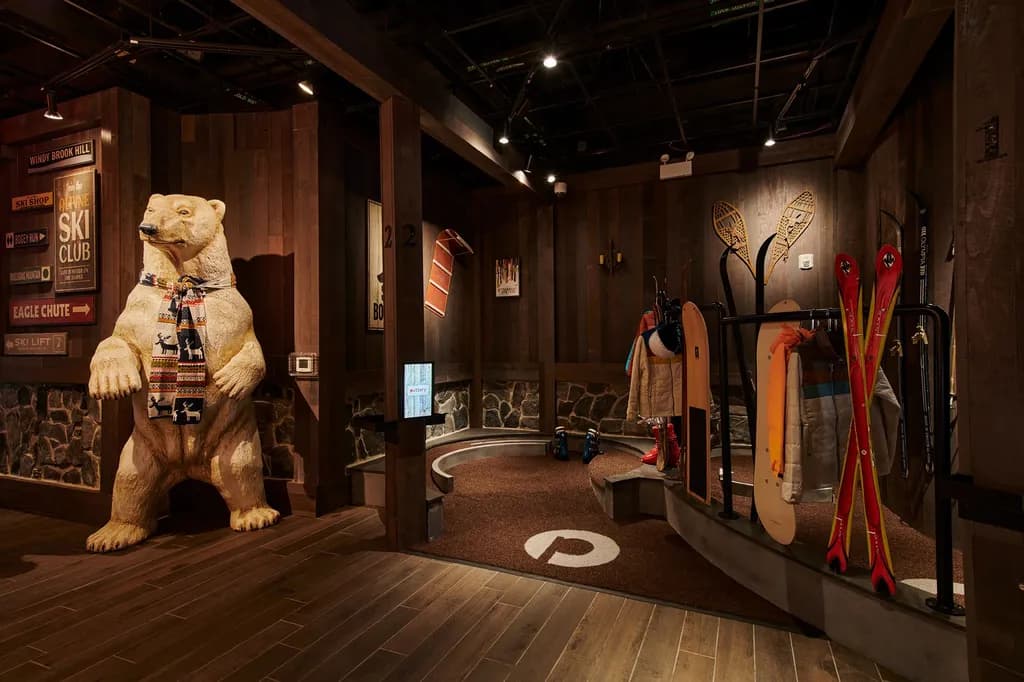 Themed ski lodge with life-sized polar bear statue, vintage ski gear.