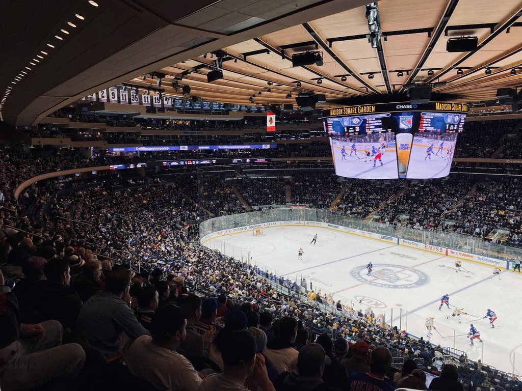 Upscale suite at Madison Square Garden for Rangers games, featuring leather seating and buffet-style catering.