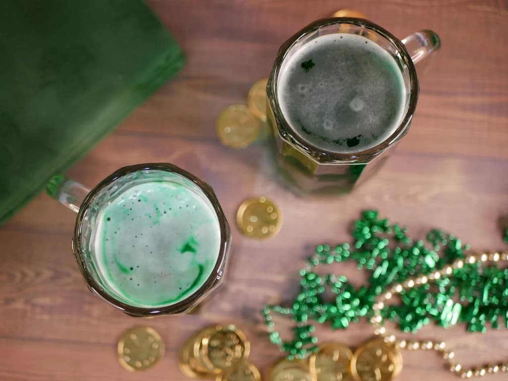 pints of green beer on a table top