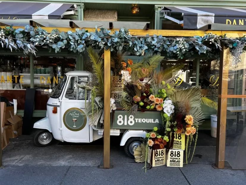 818 Tequila vintage Piaggio cart with floral decorations at Dante NYC