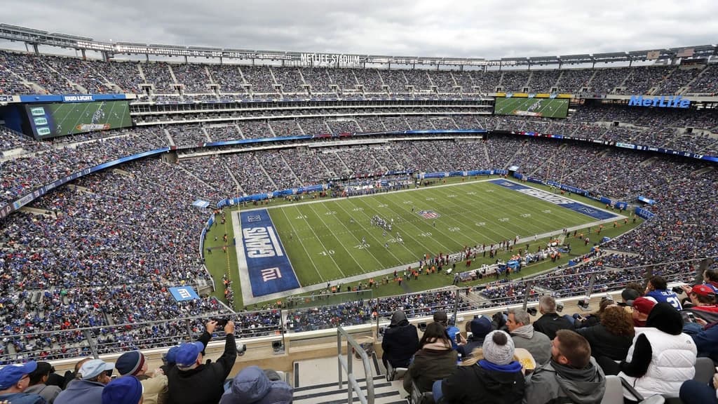 Fans watching a football game at MetLife Stadium