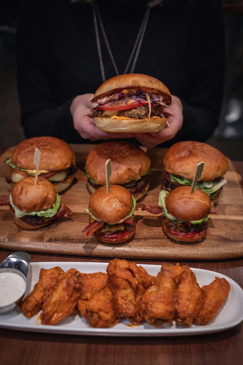 a tray of burgers, sliders, and chicken wings