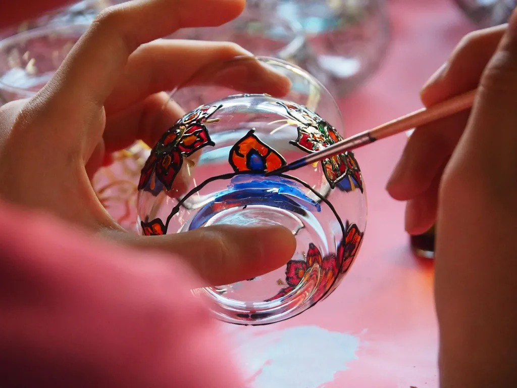 someone painting a glass