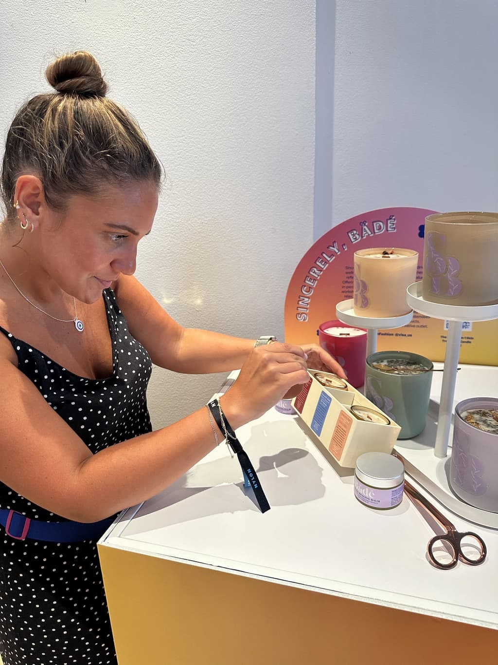 Woman smiling behind a table set for a candle-making session