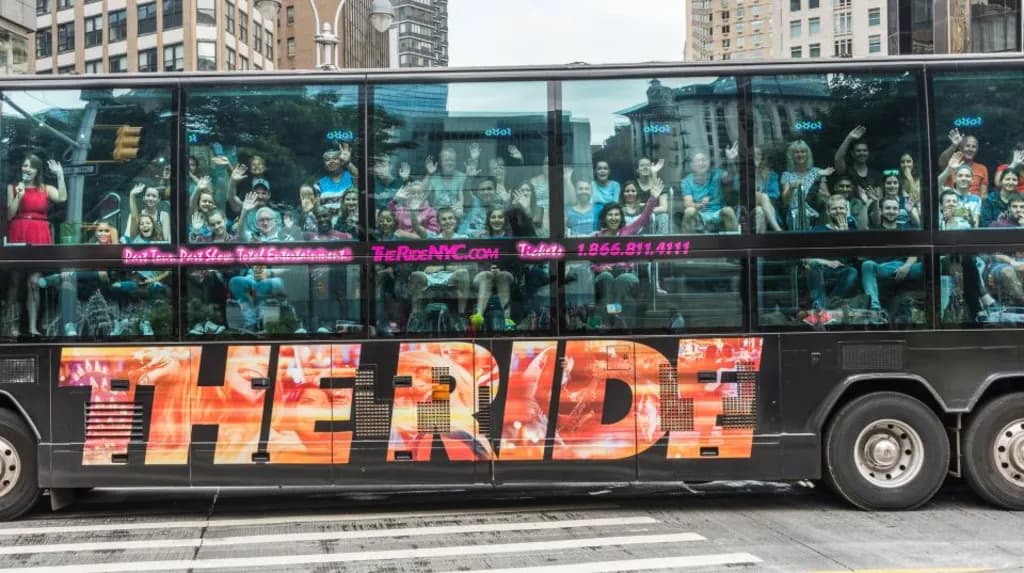 a view of a bus with people looking out the window