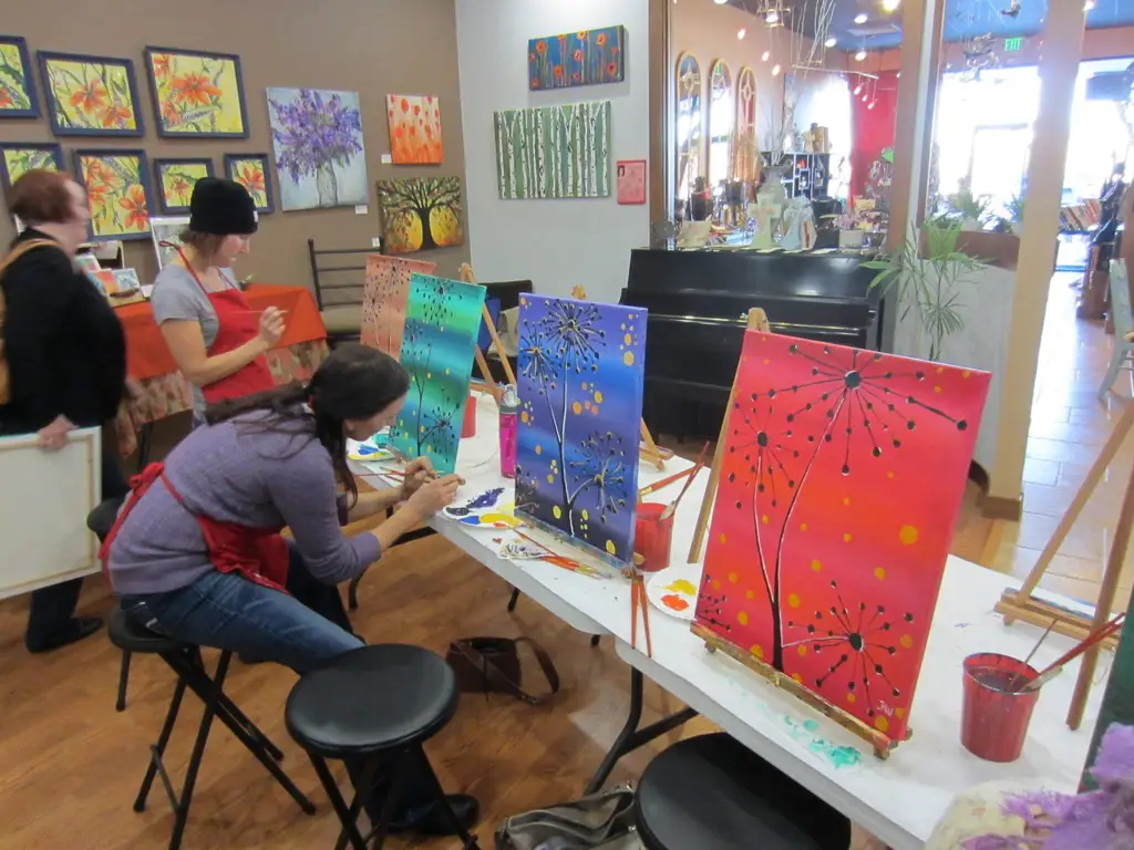 tables full of peoples art and people working on them