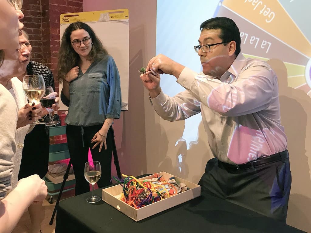 Participants enthusiastically involved in a team-building game during Picture This.