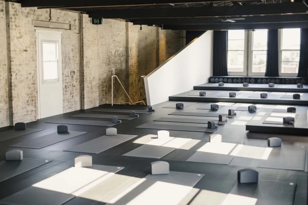 a large yoga studio with mats and blocks laid out