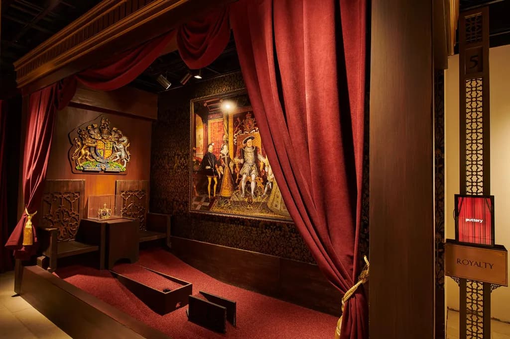Lavish throne room with royal artifacts and velvet curtains.